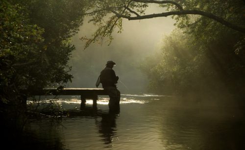 Senior Fly Fishing on a misty river
