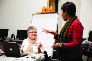 Two women talking in a tech classroom