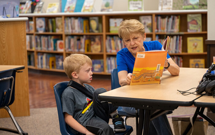 Diane Sterett reading to kindergartener Henry Stegemann