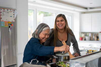 Two women preparing meal in kitchen Two women preparing meal in kitchen