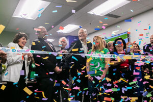 Oasis Northwest Plaza grand opening event featuring happy people celebrating with confetti and a ribbon cutting