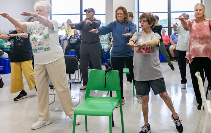 adults in a room at oasis doing balance exercises