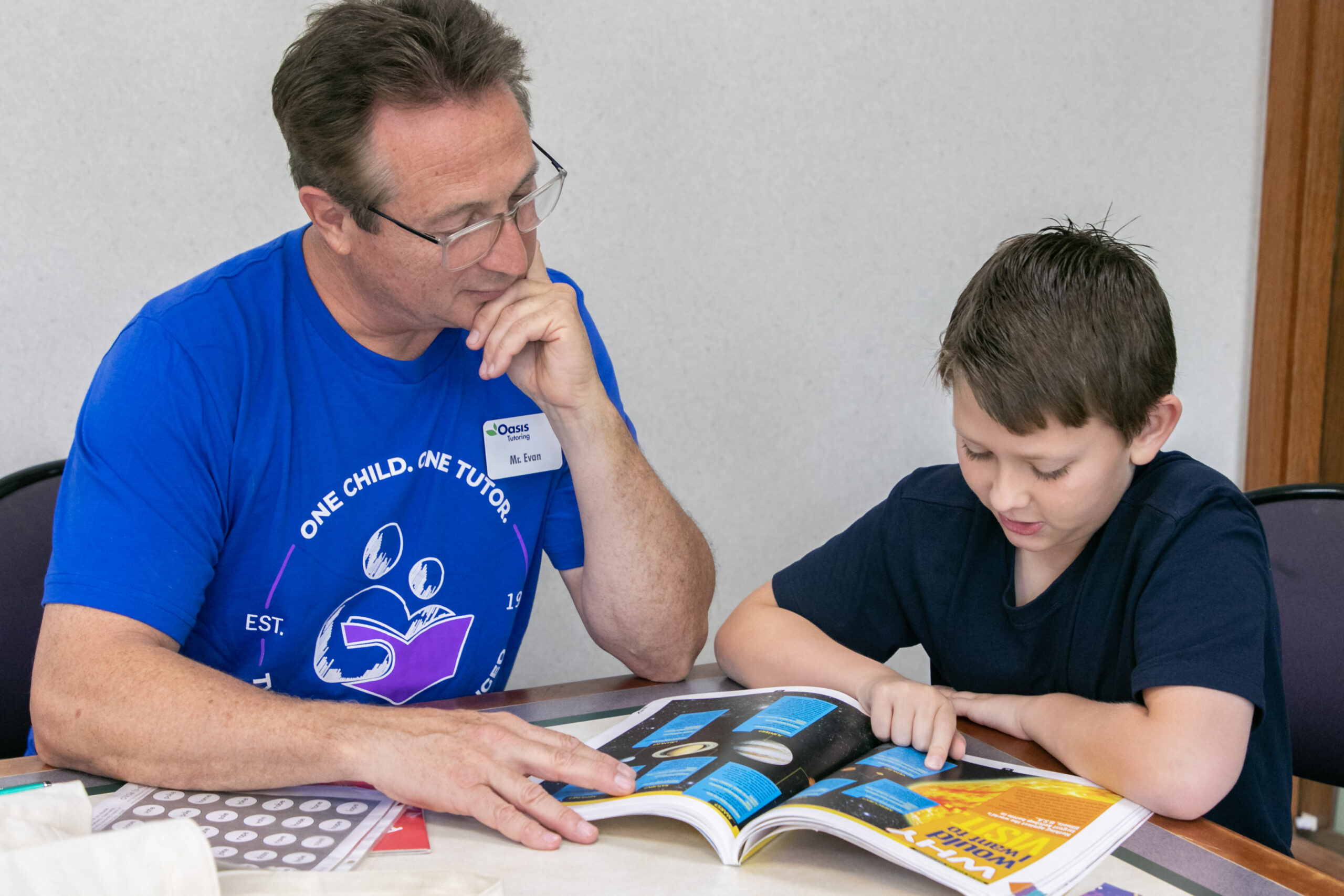 A man tutoring a child