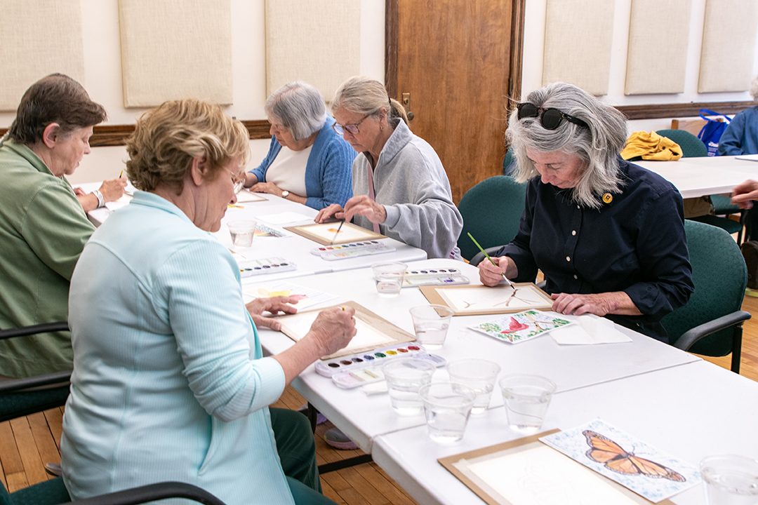A group of older women painting