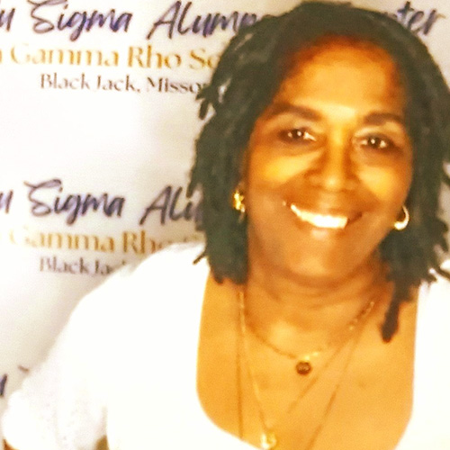 Yvette Harris Oasis participant smiling in front of white backdrop
